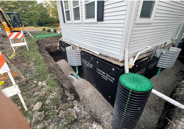 Foundation Drainage Project showing the actual footing drain-tile that Behm installed around the perimeter of the existing basement foundation and the equipment we used for this project.